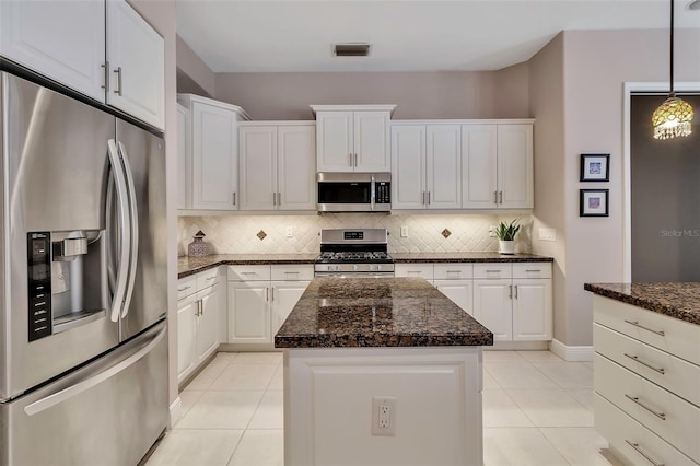 3738 Eagle Hammock Dr, Sarasota, FL 34240 - kitchen featuring tasteful backsplash, stainless steel appliances, light tile patterned flooring, and a kitchen island