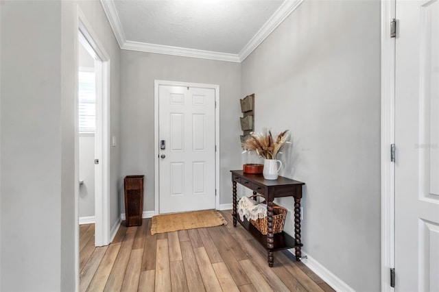 entrance foyer with baseboards, ornamental molding, and light wood finished floors