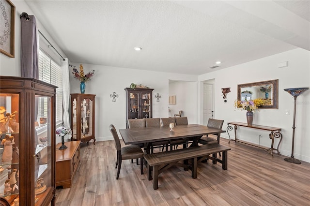 7322 34th Ct E, Sarasota, FL 34243 - dining room featuring light wood-style flooring, baseboards, recessed lighting, and a textured ceiling