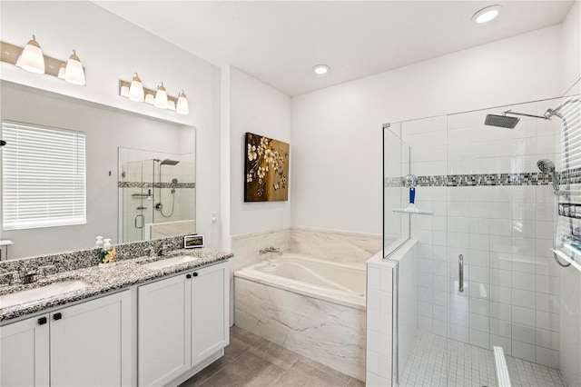 7322 34th Ct E, Sarasota, FL 34243 - bathroom with a shower stall, a bath, double vanity, tile patterned floors, and recessed lighting