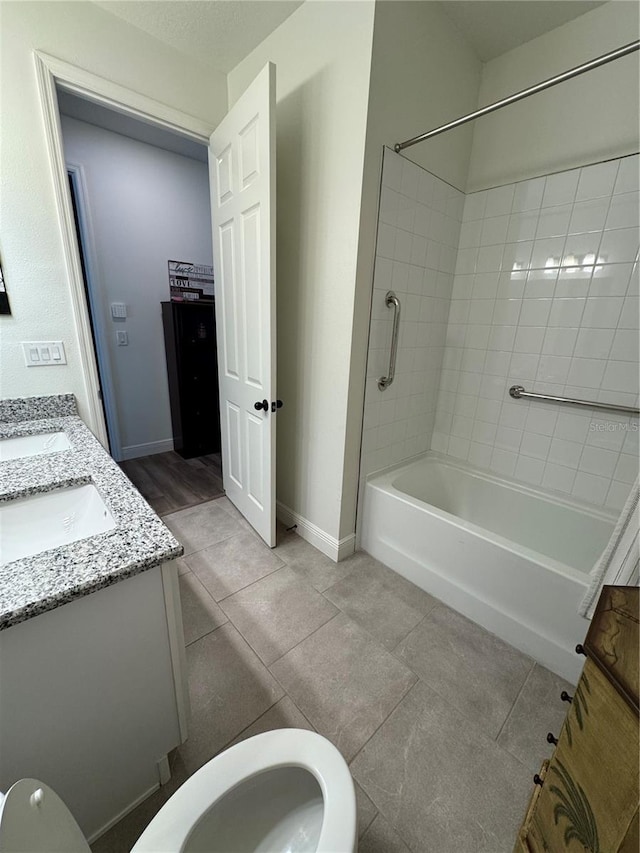 7322 34th Ct E, Sarasota, FL 34243 - bathroom featuring double vanity, toilet, tile patterned flooring, and  shower combination