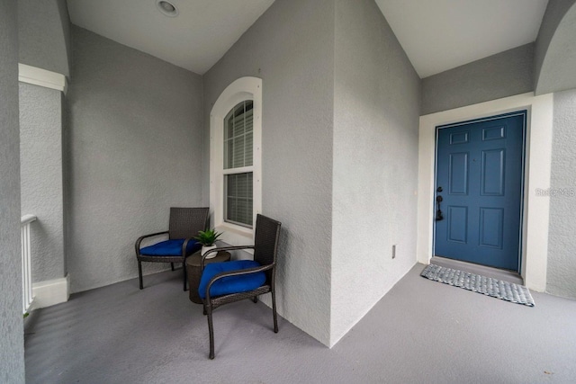 property entrance with stucco siding