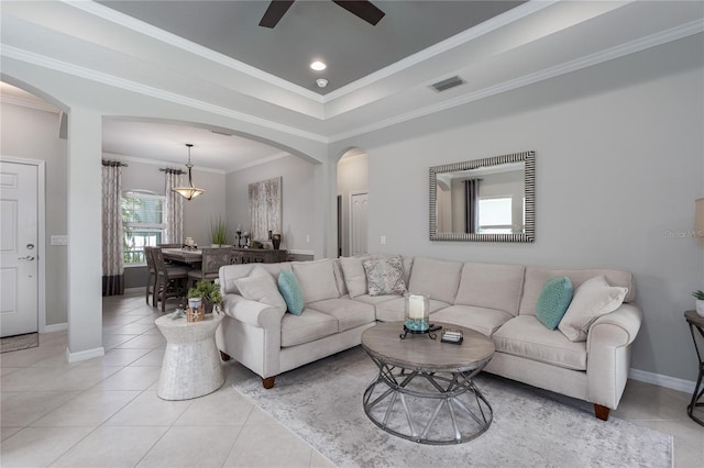 living area with visible vents, light tile patterned floors, arched walkways, baseboards, and ceiling fan