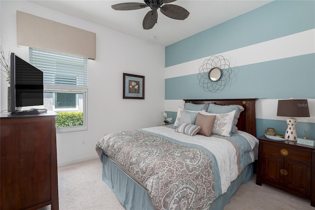 bedroom featuring ceiling fan and light carpet