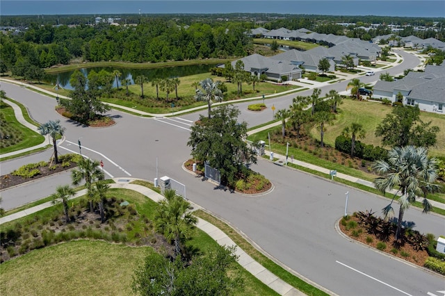 drone / aerial view featuring a residential view and a water view