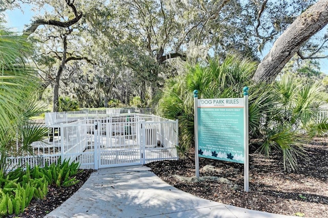 view of home's community featuring fence