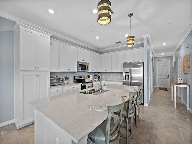 kitchen with stainless steel appliances, a sink, baseboards, white cabinets, and crown molding