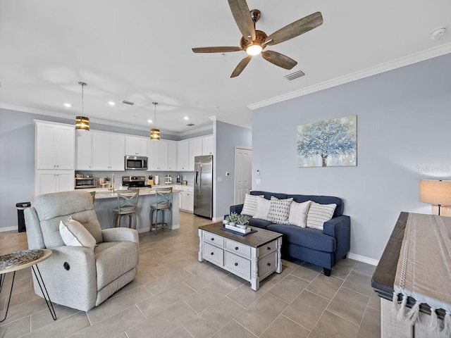 living area featuring recessed lighting, a ceiling fan, ornamental molding, and baseboards