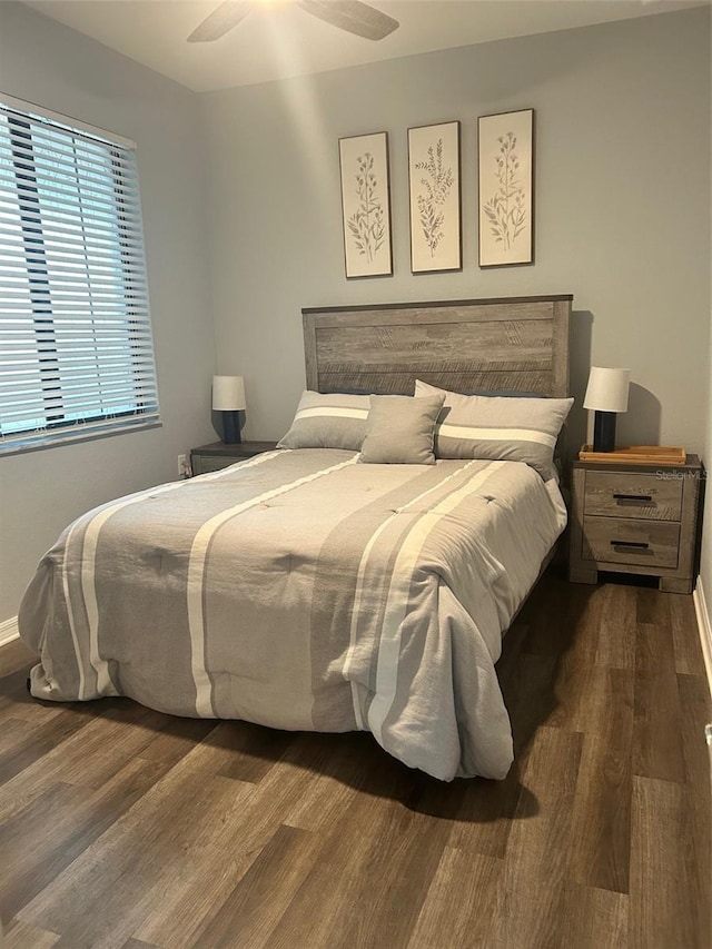 bedroom with wood finished floors and baseboards