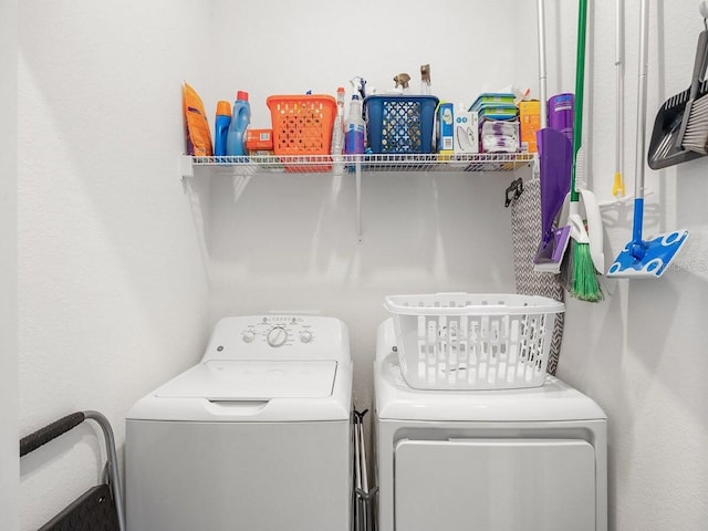 clothes washing area with washing machine and dryer