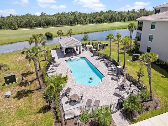 community pool with a gazebo, a water view, a patio, and view of wooded area