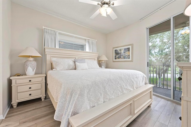 bedroom featuring multiple windows, light wood-style flooring, and access to exterior