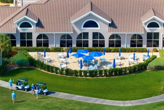 view of community with a yard and a patio