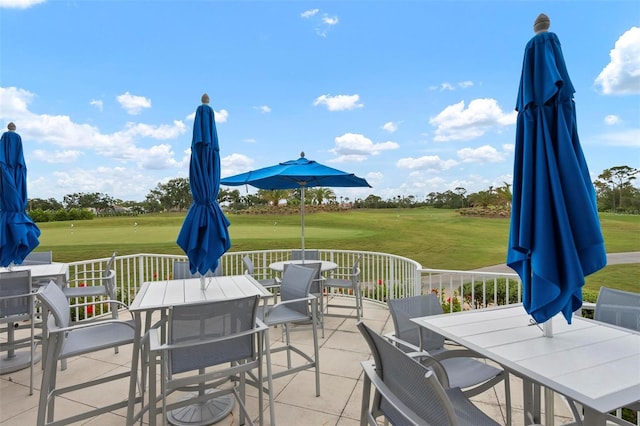 view of patio featuring outdoor dining area and golf course view