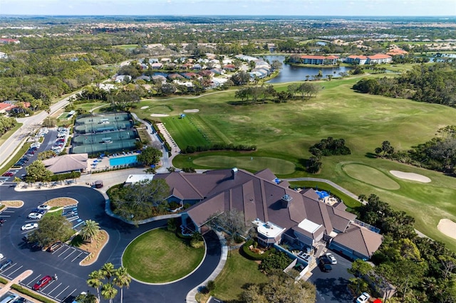 birds eye view of property with a water view, a residential view, and golf course view