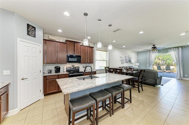 kitchen with visible vents, a sink, black microwave, ceiling fan, and electric stove