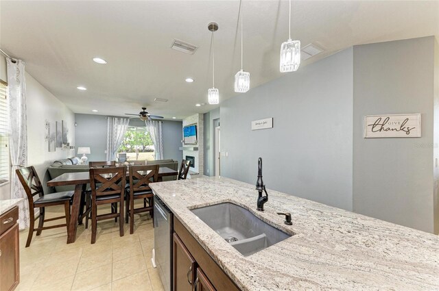 kitchen featuring pendant lighting, open floor plan, ceiling fan, recessed lighting, and a sink