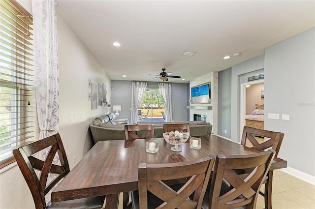 dining area with a ceiling fan, recessed lighting, light tile patterned floors, and a fireplace