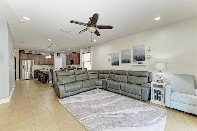 living area featuring light tile patterned floors, baseboards, a ceiling fan, and recessed lighting