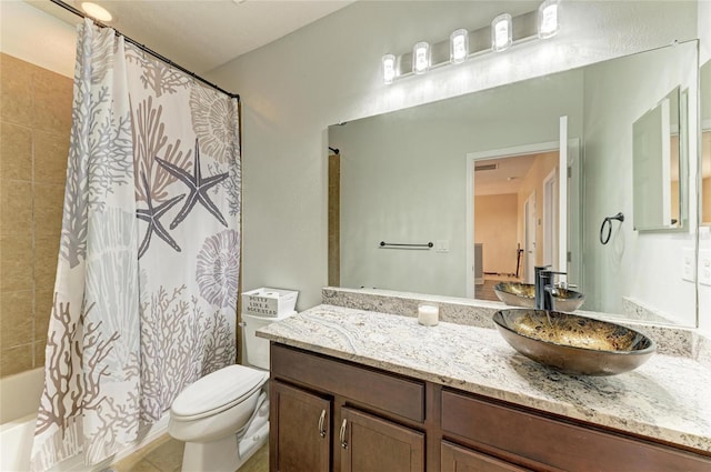 bathroom featuring vanity, shower / tub combo, and toilet