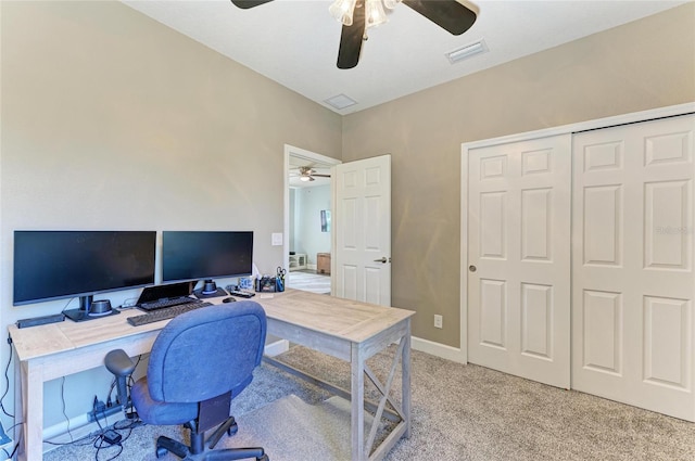 home office with ceiling fan, visible vents, and light carpet