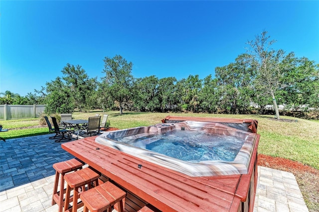 view of pool with a lawn, outdoor dining space, fence, and a patio
