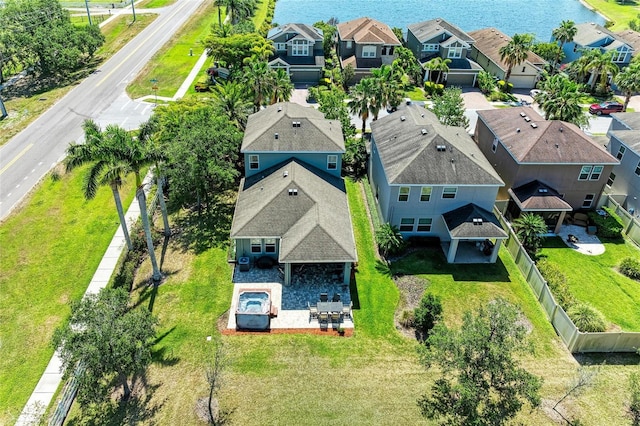 birds eye view of property featuring a residential view and a water view