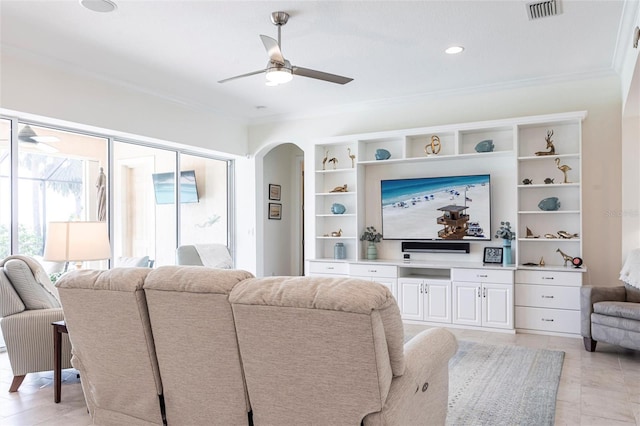 5502 Tidewater Preserve Blvd, Bradenton, FL 34208 - living room featuring ceiling fan, ornamental molding, and arched walkways