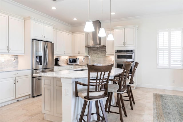 5502 Tidewater Preserve Blvd, Bradenton, FL 34208 - kitchen with appliances with stainless steel finishes, wall chimney range hood, a breakfast bar area, ornamental molding, and a kitchen island with sink