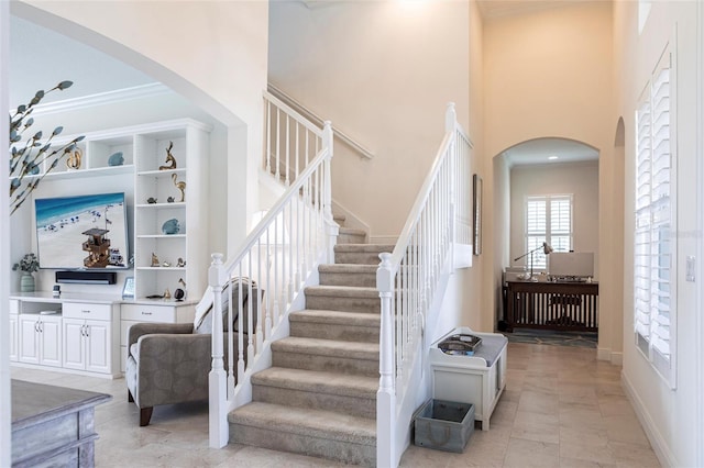 5502 Tidewater Preserve Blvd, Bradenton, FL 34208 - staircase featuring a towering ceiling, arched walkways, and baseboards