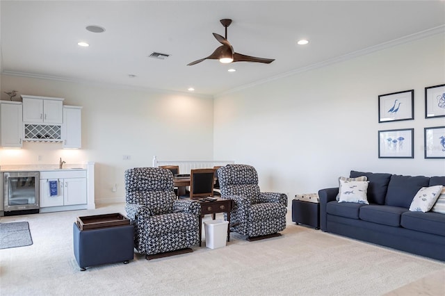 5502 Tidewater Preserve Blvd, Bradenton, FL 34208 - living room with light carpet, wet bar, a ceiling fan, beverage cooler, and ornamental molding