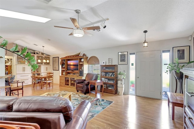 519 Bayview Ave, Osprey, FL 34229 - living room with a ceiling fan, vaulted ceiling, wood finished floors, and a textured ceiling
