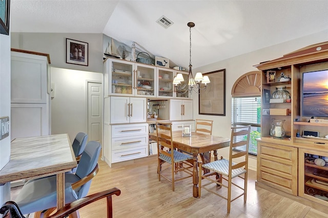 519 Bayview Ave, Osprey, FL 34229 - dining room featuring lofted ceiling, a chandelier, and light wood finished floors