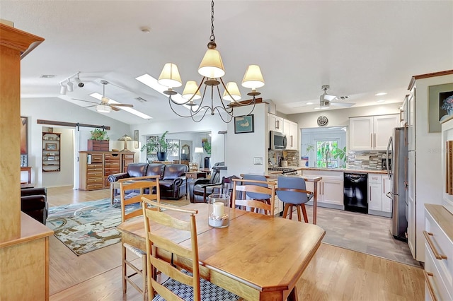 519 Bayview Ave, Osprey, FL 34229 - dining room with ceiling fan, a barn door, vaulted ceiling, light wood finished floors, and recessed lighting