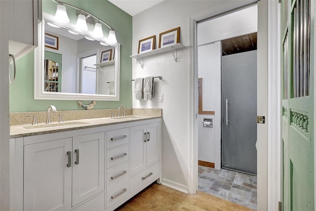 519 Bayview Ave, Osprey, FL 34229 - bathroom featuring double vanity and baseboards