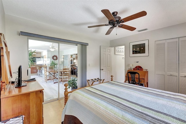 519 Bayview Ave, Osprey, FL 34229 - bedroom featuring access to exterior, a textured ceiling, ceiling fan, and a closet