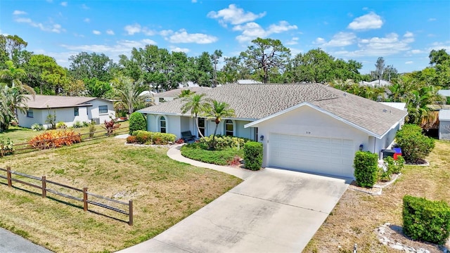519 Bayview Ave, Osprey, FL 34229 - ranch-style house with an attached garage, driveway, and stucco siding