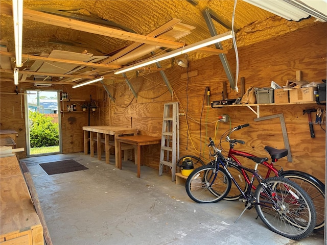 519 Bayview Ave, Osprey, FL 34229 - garage featuring wood walls and a workshop area