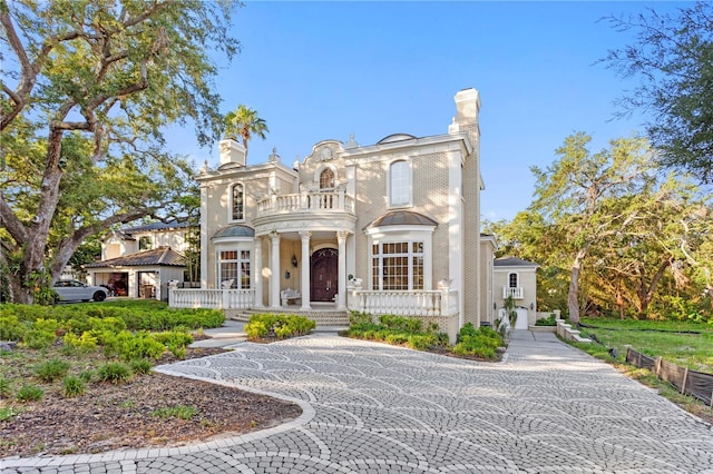 italianate-style house with covered porch and a balcony