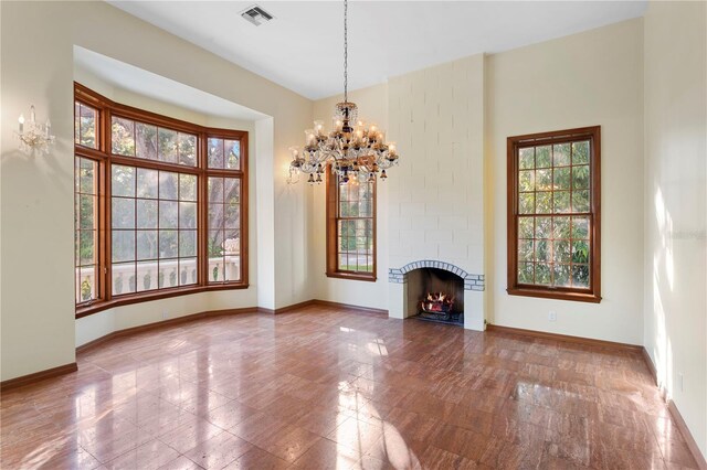 unfurnished living room with visible vents, baseboards, and plenty of natural light