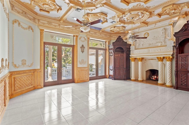 unfurnished living room featuring light tile patterned floors, ceiling fan, a fireplace, french doors, and crown molding