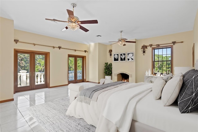 bedroom with light tile patterned floors, french doors, access to outside, and baseboards
