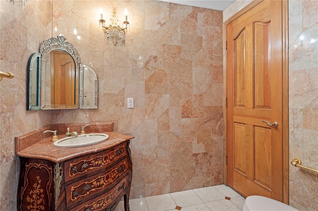 bathroom featuring tile patterned flooring, tile walls, toilet, and vanity