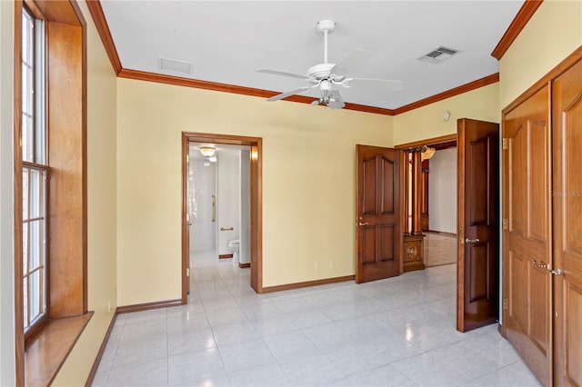 interior space featuring crown molding, visible vents, and baseboards