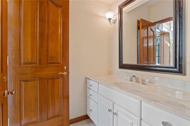 bathroom featuring vanity, tile patterned flooring, and baseboards