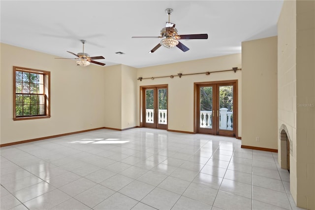 empty room featuring visible vents, a wealth of natural light, french doors, and ceiling fan