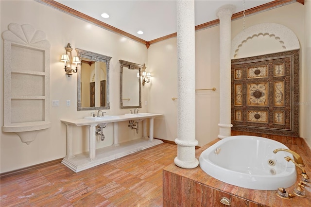 full bathroom with a whirlpool tub, a sink, and baseboards