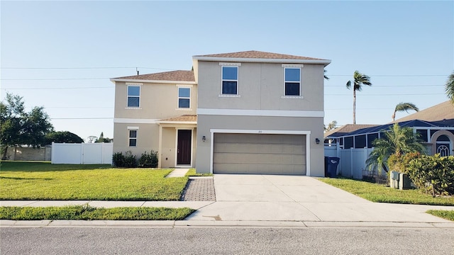 215 63rd Dr E, Bradenton, FL 34203 - traditional-style house with concrete driveway, stucco siding, an attached garage, a front lawn, and fence