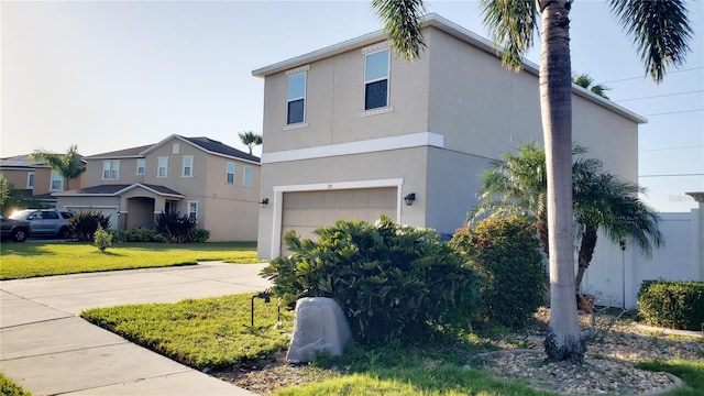 215 63rd Dr E, Bradenton, FL 34203 - view of property exterior featuring a garage, a yard, stucco siding, and concrete driveway