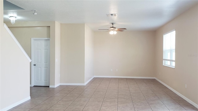 215 63rd Dr E, Bradenton, FL 34203 - empty room featuring visible vents, baseboards, a ceiling fan, and light tile patterned flooring